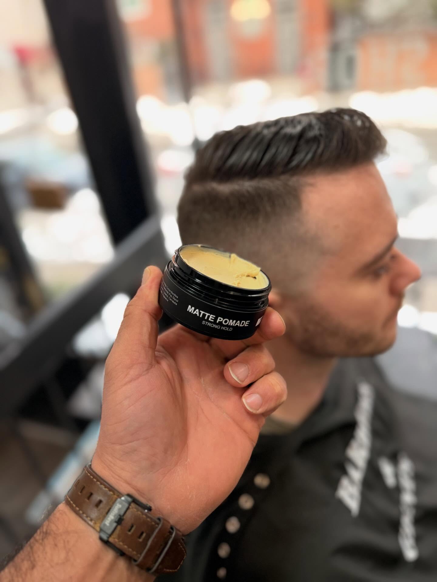 Barbers & Gents Matte Pomade held beside a finished haircut